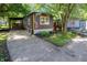 Charming home featuring dark siding, bright orange trim, and well-maintained landscaping at 71 E Cove Ct, Cicero, IN 46034