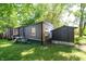 Exterior view showing dark siding, well-kept grounds, and an accompanying storage shed at 71 E Cove Ct, Cicero, IN 46034
