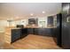Modern kitchen with black appliances, butcher block counters, and wood-look flooring at 71 E Cove Ct, Cicero, IN 46034