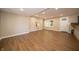 Neutral living room featuring wood-look floors, light walls, and a half wall with decor at 71 E Cove Ct, Cicero, IN 46034