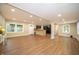 Bright open-concept living area with wood-look floors, half wall to kitchen, and lots of natural light at 71 E Cove Ct, Cicero, IN 46034