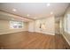 Bright living room with wood-look floors, neutral paint, and plenty of natural light at 71 E Cove Ct, Cicero, IN 46034