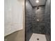 Modern walk-in shower featuring sleek dark gray tile, bronze fixtures and a white shower base at 71 E Cove Ct, Cicero, IN 46034