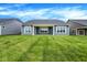 Expansive backyard featuring well-manicured lawn and a covered patio at 7195 Rose Hill Ave, Brownsburg, IN 46112