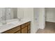 Bathroom with double sink vanity, wood cabinets, and a walk-in closet at 7195 Rose Hill Ave, Brownsburg, IN 46112