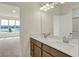 Bathroom featuring double vanity sinks, modern fixtures, and access to a bedroom at 7195 Rose Hill Ave, Brownsburg, IN 46112