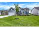 Beautiful blue single-Gathering home with a manicured lawn, attached garage and lovely landscaping at 7195 Rose Hill Ave, Brownsburg, IN 46112