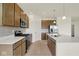 Modern kitchen with stainless steel appliances, white quartz countertops, and wooden cabinetry at 7195 Rose Hill Ave, Brownsburg, IN 46112