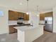 Modern kitchen with stainless appliances, a large island and pendant lighting fixtures at 7195 Rose Hill Ave, Brownsburg, IN 46112