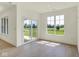 Bright living room with wood floors, large windows and sliding glass doors offering outdoor views at 7195 Rose Hill Ave, Brownsburg, IN 46112