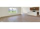 Open living room with hardwood floors adjoins a modern kitchen featuring stainless steel appliances at 7195 Rose Hill Ave, Brownsburg, IN 46112