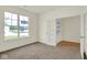 Bright room with carpet flooring and an open doorway leading to a room with attractive wood floors at 7195 Rose Hill Ave, Brownsburg, IN 46112