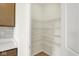 A well-organized pantry with ample shelving and lighting next to the kitchen cabinetry at 7195 Rose Hill Ave, Brownsburg, IN 46112