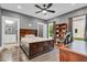 This bedroom features hardwood floors, fan and light fixture, and an adjacent bathroom at 720 Willow Pointe North Dr, Plainfield, IN 46168