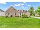 Charming brick home with a lush green lawn and thoughtfully arranged landscaping, creating a welcoming curb appeal at 720 Willow Pointe North Dr, Plainfield, IN 46168