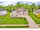 Aerial view of a well-manicured home with a brick facade, mature trees, and a spacious driveway at 720 Willow Pointe North Dr, Plainfield, IN 46168