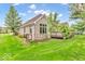 This brick house features a wooden deck, well-maintained landscaping, and a lush lawn at 720 Willow Pointe North Dr, Plainfield, IN 46168
