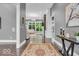 Inviting foyer features hardwood floors, neutral paint, decorative lighting, and views into the living spaces at 720 Willow Pointe North Dr, Plainfield, IN 46168
