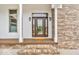 Elegant front door with sidelights, framed by classic brickwork and columns, offering a warm welcome at 720 Willow Pointe North Dr, Plainfield, IN 46168