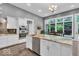 Bright kitchen with a central island, stainless steel appliances, and views of the outdoor space at 720 Willow Pointe North Dr, Plainfield, IN 46168