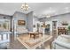 Spacious living room with hardwood floors, open layout to kitchen, and large windows that flood the space with natural light at 720 Willow Pointe North Dr, Plainfield, IN 46168