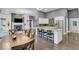 Open-concept living space with a fireplace, kitchen island, dining area, and hardwood floors at 720 Willow Pointe North Dr, Plainfield, IN 46168
