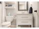 Clean and modern bathroom with a white vanity, framed mirror, neutral walls, and stylish fixtures at 7234 Fairwood Dr, Indianapolis, IN 46256