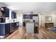 Spacious kitchen with stainless steel appliances, kitchen island, wood floors, and ample cabinet space at 7234 Fairwood Dr, Indianapolis, IN 46256