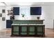 Well-lit kitchen with dark blue cabinetry, stainless steel appliances, an island with stools, and a large window at 7234 Fairwood Dr, Indianapolis, IN 46256