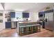 Stylish kitchen with dark blue cabinets, stainless steel appliances, and a butcher block island with seating at 7234 Fairwood Dr, Indianapolis, IN 46256