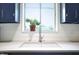 Bright kitchen sink with stainless steel faucet and view of lush greenery through the window at 7234 Fairwood Dr, Indianapolis, IN 46256