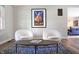 Bright living space with rounded seating, a wooden coffee table, and an eye-catching decorative poster at 7234 Fairwood Dr, Indianapolis, IN 46256
