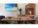 Living room with fireplace, wood floors, coffee table, and a beach scene displayed on a television at 7234 Fairwood Dr, Indianapolis, IN 46256