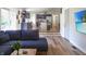 Open concept living room featuring kitchen, island, stainless steel appliances, and comfortable sofa at 7234 Fairwood Dr, Indianapolis, IN 46256