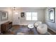 Cozy living area showcasing stylish furnishings, a patterned rug, wood floors, and bright natural light at 7234 Fairwood Dr, Indianapolis, IN 46256