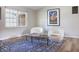 Comfortable seating area featuring rounded chairs, a wooden coffee table, and a large, sunny window at 7234 Fairwood Dr, Indianapolis, IN 46256