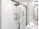 Modern bathroom shower featuring a sleek sliding glass door, handheld shower and subway tile at 7234 Fairwood Dr, Indianapolis, IN 46256