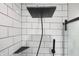 Contemporary shower with rainfall shower head, handheld sprayer and bench complimented by subway tile at 7234 Fairwood Dr, Indianapolis, IN 46256