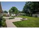 Backyard with patio, fire pit, storage shed, and green lawn at 7401 N Layman Ave, Indianapolis, IN 46250