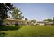 Well-maintained backyard featuring a large grassy area and mature trees at 7401 N Layman Ave, Indianapolis, IN 46250