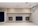 Finished basement featuring a painted brick fireplace with built-in shelving at 7401 N Layman Ave, Indianapolis, IN 46250