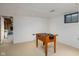 Basement space with a foosball table, recessed lighting and a small window at 7401 N Layman Ave, Indianapolis, IN 46250