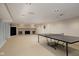 Spacious basement rec room with a ping pong table and fireplace for recreation at 7401 N Layman Ave, Indianapolis, IN 46250
