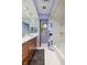 Well-lit bathroom with a shower/tub combo and ample storage space at 7401 N Layman Ave, Indianapolis, IN 46250