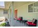 Relaxing covered patio featuring cozy seating and views of the landscaped backyard at 7401 N Layman Ave, Indianapolis, IN 46250