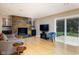 Inviting living room showcasing a stone fireplace, bamboo flooring, and sliding doors to the patio at 7401 N Layman Ave, Indianapolis, IN 46250