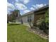 Landscaped backyard featuring a wooden pergola and well-maintained lawn at 7608 Mather Ln, Indianapolis, IN 46239