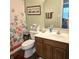Bathroom featuring a floral shower curtain, a single sink vanity, and a large mirror at 7608 Mather Ln, Indianapolis, IN 46239