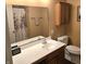 Bathroom with a single sink vanity, decorative mirror and cabinet for storage at 7608 Mather Ln, Indianapolis, IN 46239