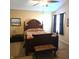 Bedroom with a ceiling fan, a decorative headboard, a window, and neutral colored walls at 7608 Mather Ln, Indianapolis, IN 46239